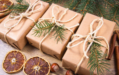 Christmas gifts in rustic boxes on wooden background.