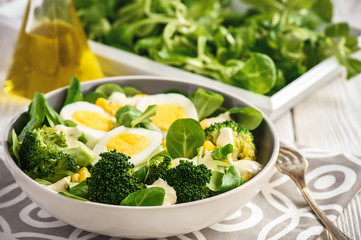 Healthy vegetarian salad with eggs, broccoli, corn and cheese