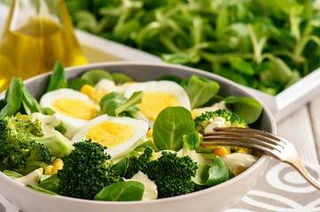 Healthy vegetarian salad with eggs, broccoli, corn and cheese