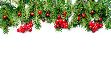 New Year`s composition of fir branches and berries of viburnum on a white background isolated