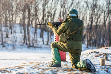 Slow motion closeup of soldier and his military gun during special training exercise