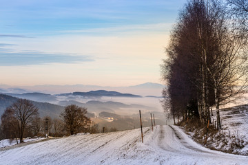 snowy street with mountain view