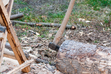 Axe in a pine log, pine sawhorse, focus on the axe.