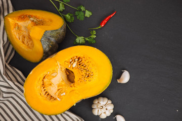 Cut Pieces of Pumpkin with seeds in Wooden Plate on the Wooden Board.Harvest,Fresh Vegetable, Ingredient.White Food Background.Top View