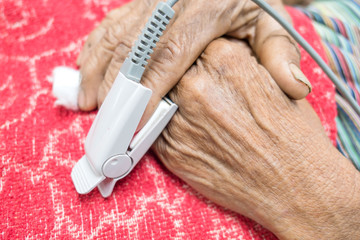 Pulse oximeter in a male patient's fingertip in hospital .
