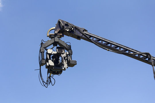Professional camera on the crane against the sky
