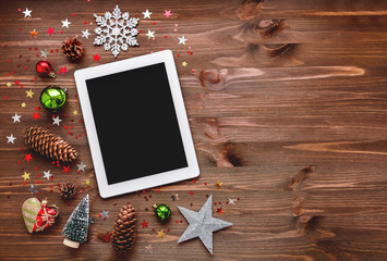 Fototapeta na wymiar Christmas and New year background with tablet and decorations. Place for text. Mock up, flat lay.