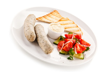 Breakfast - boiled white sausages, toasts and vegetables
