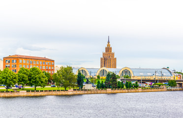 view of the zeppelin hangars and the academy of sciences building next to a steel railway bridge in the Latvian capital Riga. © dudlajzov