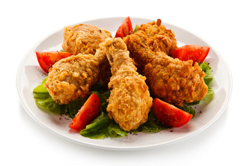 Fried chicken drumsticks on white background
