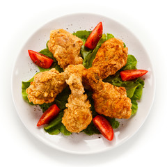 Fried chicken drumsticks on white background