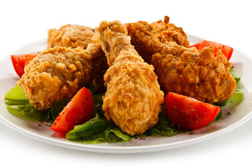 Fried chicken drumsticks on white background