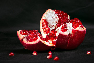 cut garnet on a dark background, still life with a pomegranate