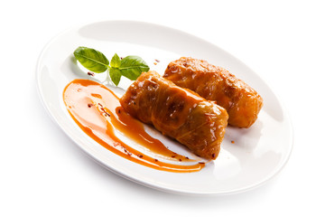 Wrapped meat with tomato sauce on white background