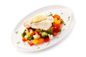 Fish dish - fried fish fillet and vegetables on white background