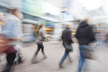 A shopper walking against shop window