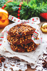 Christmas and New Year background with decorations, pine cones and stack of tasty cookies with holiday ribbon.