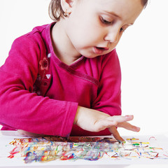 beautiful little baby girl draws a picture paints (talent, creativity concept)