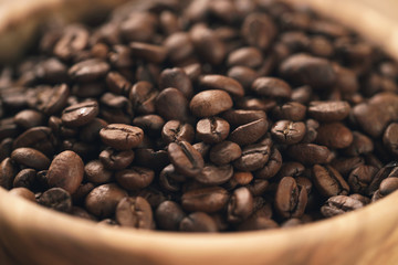 roasted coffee beans in wood bowl on table