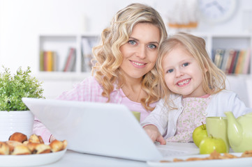 mother and children with laptop