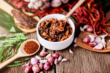 thai tradition style spicy dipping mad frop pork and shirmp with spicy and herb for ingredient on wooden texture table