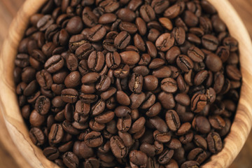 roasted coffee beans in wood bowl