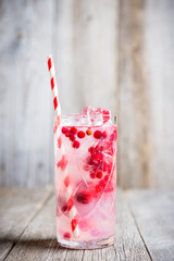 Tasty christmas cocktail with cranberry and foxberry. Shallow depth of field. Selective focus.