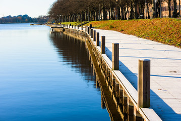 Lakeside promenade on sunny fall morning with a thin layer of hoarfrost on the walkway. Location...