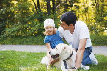 happy family with pet dog at picnic in a Sunny summer day. pregn