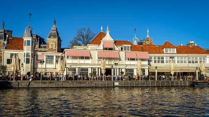 Fototapeta premium People sitting in Cafe restaurant on the canal in Amsterdam, the Netherlands, October 13, 2017