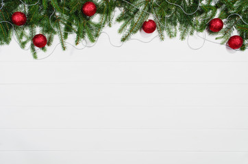 Fototapeta na wymiar Christmas background frame top view on white wooden plank table background with copy space around products. Decorations isolated on white. Horizontal composition.