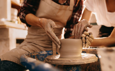 Two women at a pottery workshop making clay pots © Jacob Lund