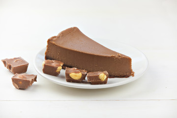chocolate cheesecake on white plate on  wooden table