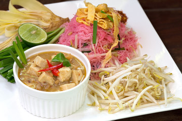 Stir Fried Noodle with coconut milk in white dish Thai food