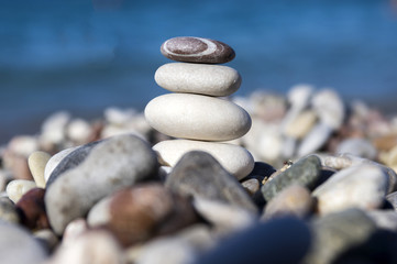Fototapeta na wymiar Stones and pebbles stack, harmony and balance, one stone cairn on seacoast