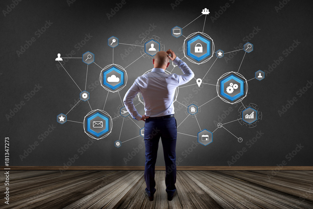 Poster businessman in front of a wall with a business network connection displayed on a futuristic interfac