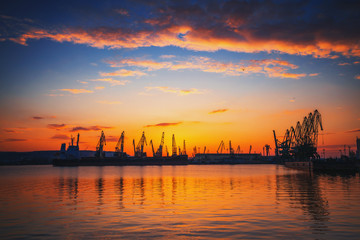 Naklejka premium Sunset over sea port and industrial cranes, Varna
