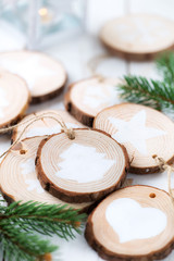 Christmas celebration concept. Self made festive decorations made of wood slices and white painted ornaments