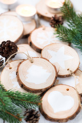 Christmas celebration concept. Self made festive decorations made of wood slices and white painted ornaments