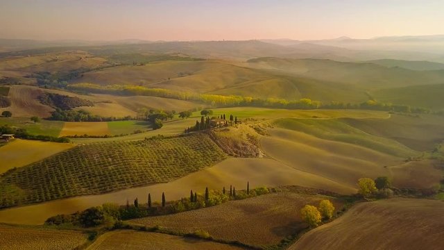 tuscany val d'orcia countryside aerial view flying over at sunrise