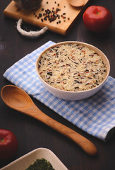 whole grain mix rice on the blue towel with a wood spoon