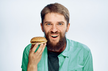 A man in green uniform looks forward to his hamburger