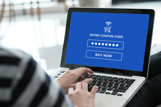 Woman typing discount coupon code on laptop screen to get the shopping on line promotion, on line shopping ,digital marketing business and technology, lifestyle concept