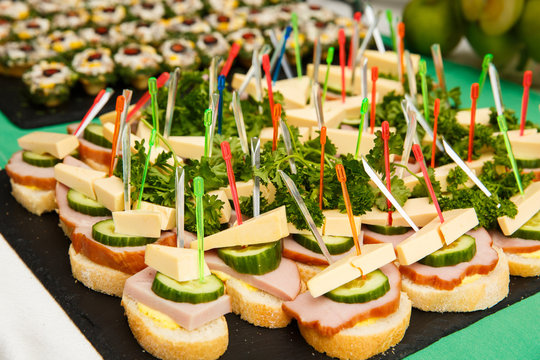 bruschetti or canapes with cheese, olives, ham, cucumber