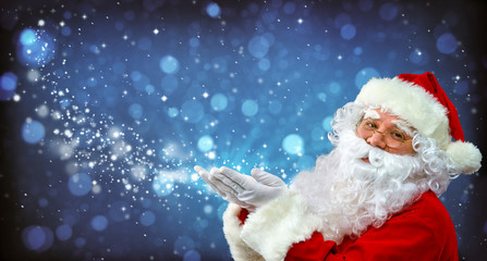 Santa Claus with magic light in his hands