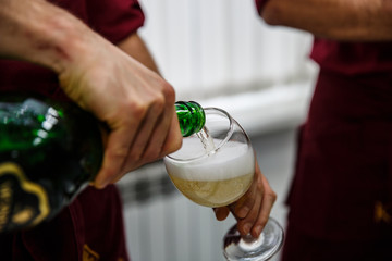 Pouring champagne into glass at hen-party, close up