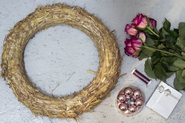 wreath, pink baubles, roses and silver gift box for the preparation of Christmas garland