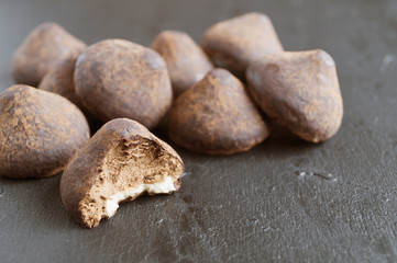 Chocolate truffles on a grey background.