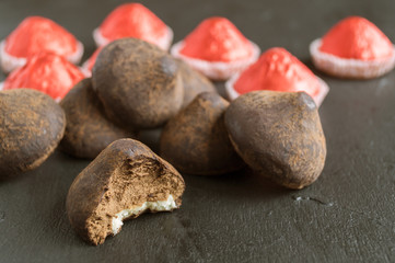 Chocolate truffles on a grey background.