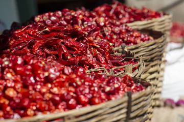 Dried red chills spices of Thailand. Blur picture. Red hot chili peppers in baskets at the local market